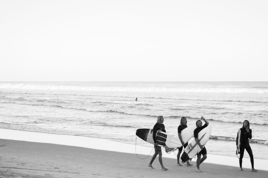 Black and white surfers at the beach